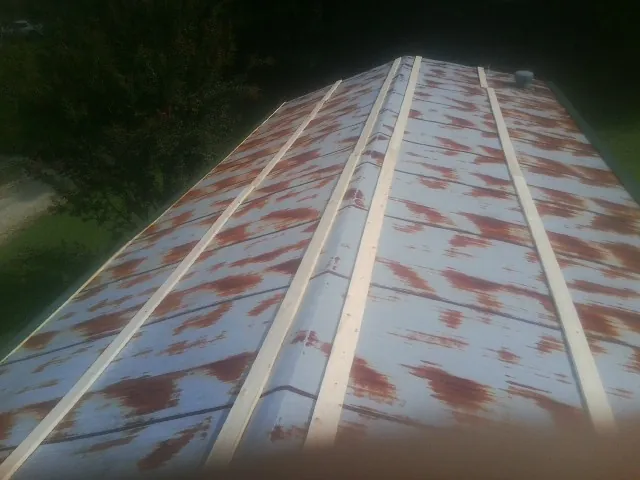 Rusted metal roof panels with new wood purlins before replacement — Storm Damage Roof Repair in Linesville by Roofing Brothers